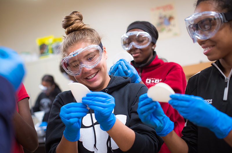 Photo of three students working on a science lab