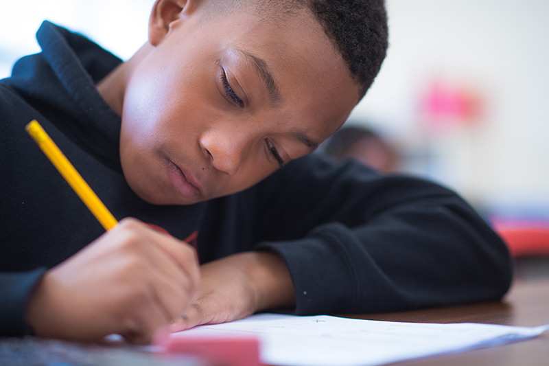 Photo of a boy writing in class